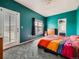 The Primary bedroom with bright turquoise walls, closet, neutral carpet, and patio doors at 9363 Amison Cir # 106, Parker, CO 80134