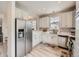 Bright, modern kitchen features stainless steel appliances, white cabinetry and ample counter space at 9363 Amison Cir # 106, Parker, CO 80134