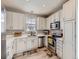 A kitchen with white cabinets, modern appliances, and ample countertop space provides a clean, functional design at 9363 Amison Cir # 106, Parker, CO 80134