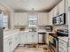 Modern kitchen with white cabinets, stainless steel appliances, and stylish accents for a contemporary feel at 9363 Amison Cir # 106, Parker, CO 80134