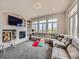 A well-lit living room features a cozy fireplace, plush seating, and plenty of natural light at 9363 Amison Cir # 106, Parker, CO 80134