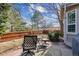 Cozy backyard patio with mature trees and wooden fence at 16302 Parkside Dr, Parker, CO 80134