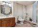 Neutral bathroom with a decorative mirror and a wooden vanity at 16302 Parkside Dr, Parker, CO 80134