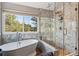 Elegant bathroom featuring a soaking tub, a large window, and a separate glass-enclosed shower at 16302 Parkside Dr, Parker, CO 80134
