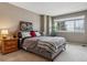 Inviting bedroom with large window, bedside table, and neutral color scheme at 16302 Parkside Dr, Parker, CO 80134