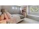 Cozy bedroom features natural light, neutral colors and a built-in desk area at 16302 Parkside Dr, Parker, CO 80134