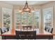 Bright dining area featuring large windows, custom blinds, and a rustic chandelier creating a warm and inviting atmosphere at 16302 Parkside Dr, Parker, CO 80134