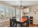 The dining area features lots of natural light, a modern chandelier, and a table for four, perfect for a casual meal at 16302 Parkside Dr, Parker, CO 80134