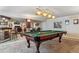 Spacious finished basement with a pool table and a seating area for entertaining at 16302 Parkside Dr, Parker, CO 80134