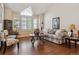 Inviting living room boasts hardwood floors, large windows with plantation shutters, and a comfortable seating arrangement at 16302 Parkside Dr, Parker, CO 80134