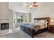 Inviting main bedroom featuring a bay window, fireplace and a plush, carpeted floor at 16302 Parkside Dr, Parker, CO 80134