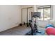 Spare bedroom or gym area featuring workout equipment, a large window, and closet with mirrored doors at 16302 Parkside Dr, Parker, CO 80134