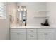 Stylish bathroom boasts a double sink vanity, quartz counters, and floating shelves at 4947 Stoneham Ave, Castle Rock, CO 80104