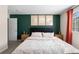 Comfortable bedroom featuring a dark green accent wall and natural wood nightstands at 4947 Stoneham Ave, Castle Rock, CO 80104