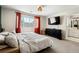 A calming primary bedroom with a light-filled ensuite bathroom with red curtains at 4947 Stoneham Ave, Castle Rock, CO 80104