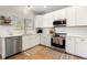 Well-lit kitchen with stainless steel appliances and modern white cabinetry at 4947 Stoneham Ave, Castle Rock, CO 80104