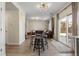 Inviting living space with a kitchen featuring stainless steel appliances, a dining area with barstools, and wood floors at 4947 Stoneham Ave, Castle Rock, CO 80104
