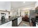 Modern kitchen featuring updated stainless appliances, quartz countertops, and sleek white cabinetry, ideal for cooking enthusiasts at 739 S Utica St, Denver, CO 80219