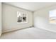 A bright bedroom with neutral carpet features a large window for natural light at 2596 Bailey Ln, Erie, CO 80026