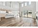 This open-concept living space features soaring ceilings, abundant natural light, and adjoins a modern kitchen at 2596 Bailey Ln, Erie, CO 80026