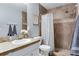 Bathroom with walk-in shower, vanity with countertop, and decorative towels at 1179 S Alton Ct, Denver, CO 80247