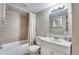 Cozy bathroom with large mirror, white vanity, and shower and tub combination at 1179 S Alton Ct, Denver, CO 80247