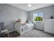 Bright bedroom with a teddy bear on the bed and a view of the backyard at 1179 S Alton Ct, Denver, CO 80247