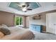 Spacious bedroom featuring a ceiling fan, a large window, and a blue dresser at 1179 S Alton Ct, Denver, CO 80247