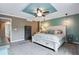 Spacious bedroom with tray ceiling, ceiling fan, and neutral decor at 1179 S Alton Ct, Denver, CO 80247