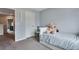 Cozy bedroom with a teddy bear on the bed and white shelving at 1179 S Alton Ct, Denver, CO 80247