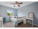 Well-lit bedroom with a blue accent wall and comfortable furnishings at 1179 S Alton Ct, Denver, CO 80247