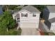 Well-maintained two-story home with a two car garage and neatly landscaped front yard at 1179 S Alton Ct, Denver, CO 80247
