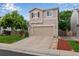 Two-story home with a two-car garage, landscaped yard, and a well-manicured lawn at 1179 S Alton Ct, Denver, CO 80247