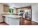 Modern kitchen with stainless steel appliances, granite countertops, and ample cabinet space at 1179 S Alton Ct, Denver, CO 80247