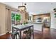 Modern kitchen with stainless steel appliances, breakfast bar, and adjacent dining area at 1179 S Alton Ct, Denver, CO 80247