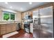 Well-equipped kitchen with stainless steel appliances, granite countertops, and natural light at 1179 S Alton Ct, Denver, CO 80247