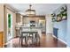 Well-lit kitchen with stainless steel appliances, sleek countertops, and stylish dining area at 1179 S Alton Ct, Denver, CO 80247