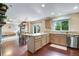 Open-concept kitchen with granite countertops, stainless steel appliances, and views of the living and dining areas at 1179 S Alton Ct, Denver, CO 80247