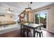 Open-concept living and dining area with fireplace, TV, and access to patio at 1179 S Alton Ct, Denver, CO 80247