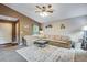 Bright living room with a plush sectional sofa, neutral carpet, and stylish decor at 1179 S Alton Ct, Denver, CO 80247