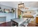 Open-concept living and dining area featuring modern light fixture and comfortable seating arrangement at 1179 S Alton Ct, Denver, CO 80247