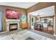 Cozy living room with a fireplace, opening to the kitchen and dining area at 1179 S Alton Ct, Denver, CO 80247
