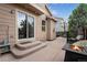 Outdoor patio with a firepit, seating, string lights, and a nearby basketball hoop at 1179 S Alton Ct, Denver, CO 80247