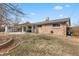 Brick house backyard with a covered patio and a garden area, ideal for outdoor living at 2572 Beech Ct, Golden, CO 80401
