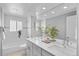 Bright bathroom featuring double sinks with modern fixtures, large mirror, and natural light at 2572 Beech Ct, Golden, CO 80401