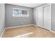 Clean bedroom features hardwood floors, built-in closet, and bright window at 2572 Beech Ct, Golden, CO 80401