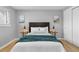 Bedroom with matching side tables, light-colored walls and wood flooring, illuminated by lamps at 2572 Beech Ct, Golden, CO 80401