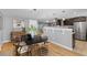 Open dining area with modern lighting, stylish table and seating, and seamless flow to the kitchen at 2572 Beech Ct, Golden, CO 80401