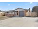 Single-story home with brick accents, a well-maintained lawn, and an attached garage with driveway at 2572 Beech Ct, Golden, CO 80401