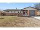 Charming single-story home with brick accents, a well-maintained lawn, and an attached garage at 2572 Beech Ct, Golden, CO 80401